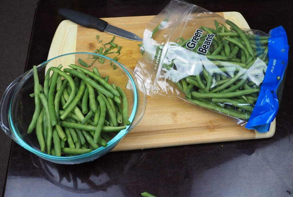 Trimming off the green beans.
