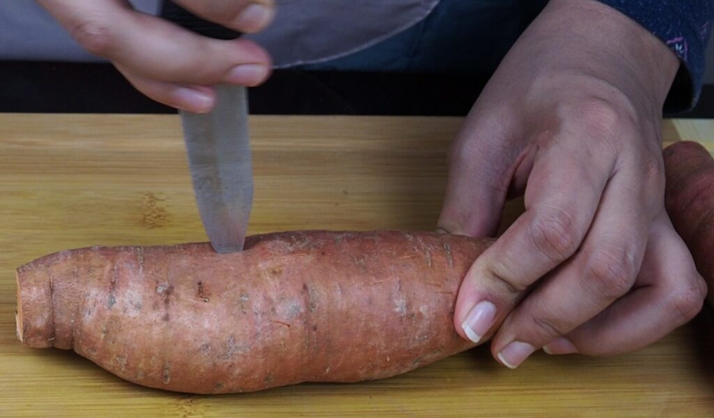 Washed sweet potato and pierced hole through it using fork or your kitchen knife.
