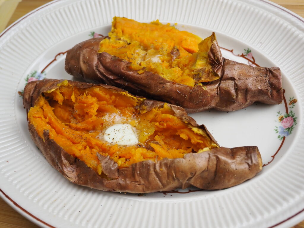 Delicious baked sweet potato with melted butter ready to eat.